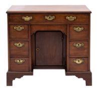 A mid 18th Century mahogany kneehole desk:, the rectangular top with a moulded edge,