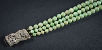 A graduated jade bead three-string necklace: the individually knotted beads graduate from 5mm to