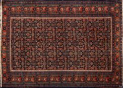 A Feraghan rug:, the indigo field with an all over geometric design,