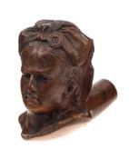 A late 19th Century carved wooden pipe bowl: in the form of a woman's head with a large ribbon bow