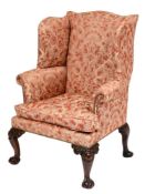 An 18th Century and later carved mahogany wing frame armchair:, fully upholstered,
