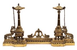 A pair of 19th Century brass chenets: the Roman style lamp with acorn finial mounted on a fluted