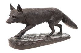 A bronze study of a prowling fox: mounted on an oval naturalistic base, unsigned, 57cm long.