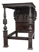 A 19th Century carved oak four poster bed in the Elizabethan taste:,