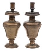 A pair of 19th Century bronze candlesticks: with plain cylindrical nozzles,
