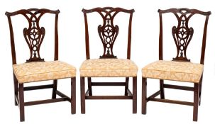 A set of six George III and later carved mahogany dining chairs in the Chippendale taste:,
