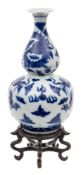 A Chinese blue and white double gourd 'Dragon' vase: painted overall with dragons chased flaming