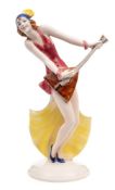 A William Goebels Art Deco figurine: modelled as an elegant balalaika player on a domed circular