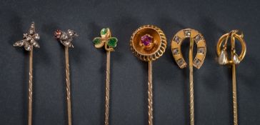 A diamond mounted stick-pin with fly motif, a stick-pin with butterfly motif,