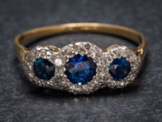 A sapphire and diamond triple cluster ring: the graduated circular sapphires within a surround of