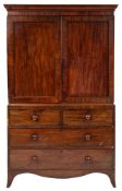 An early 19th Century mahogany linen press:, the upper part with a moulded cornice,