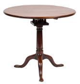 A mid 18th Century mahogany circular tea table:, the snap top on turned central pillar,