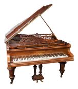 A late 19th Century rosewood cased grand piano by Bechstein,: with fret carved music stand,