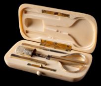 A late Victorian ivory necessaire: of rectangular outline, fitted with scissors, thimble,