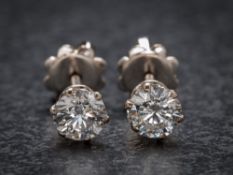 A pair of 18ct white gold and diamond ear-studs: each with a circular brilliant-cut diamond