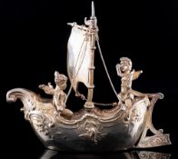 A Continental model of two cherubs in a sailing boat, bears import marks for Berthold Muller,