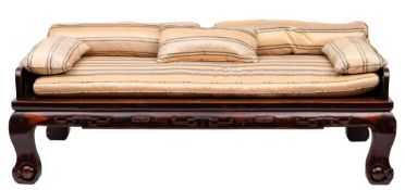 A large Chinese hardwood day bed: the shaped three quarter back and elbow supports over a reeded