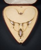 An Art Nouveau gold and mother of pearl necklace: of openwork whiplash links inset with mother of