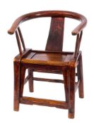 A Chiense elm armchair: of curved outline with solid central splat and panelled seat,