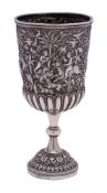 An Indian silver cup: the bowl with embossed hunting scene and half reeded decoration,