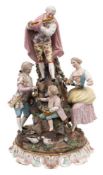 A late 19th century Dresden porcelain 'Musical' group: in the form of a standing gallant playing