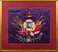 A WWI period woolwork picture: having central black and white portrait of a gunner with HMS Goliath