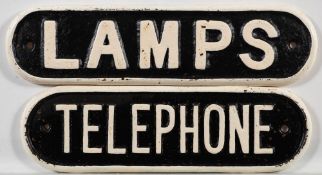 Two cast iron doorplates 'Lamps and 'Telephone': 8 x 21cm and 9 x 29cm respectively.