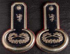 A pair of Scottish silver plated epaulettes by G Larken: lion rampant with axe over crossed swords