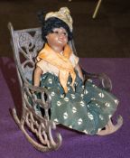 A SFBJ black bisque head doll:, together with a cast iron rocking chair.