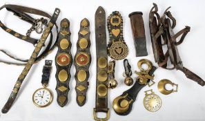 A collection of late 19th/early 20th century horse brasses and tack: and a pair of wooden soled ice