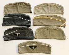 A group of seven reproduction German forage caps.