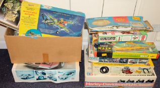 A collection various empty model kit boxes containing associated built model kits of cars,: etc.