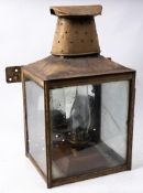 A large station wall lantern: of square form with oval chimney and circular reflector to interior,