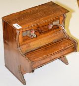 An early 20th century German toy upright piano: with xylophone to upper section,