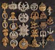 A group of various regimental cap badges: including Northamptonshire,