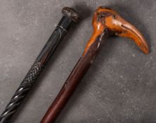 A late 19th/early 20th century Folk Art root wood walking cane of natural form with stylised bird's