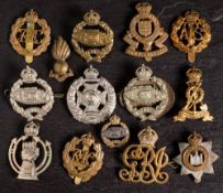 A small group of WWII cap badges: including Tank Regiment, RAC, Devonshire Regiment and others.