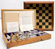 A cased Franklin Mint 'Tournament of Camelot' chess set and board: the cast pewter pieces