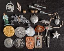 A small group of WWII German lapel pins: comprising three stick grenade pins,