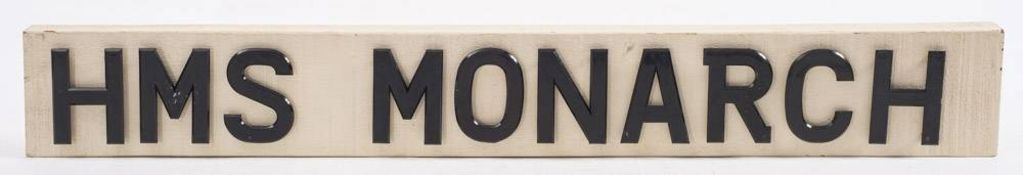 A scratch built ship's name plate 'HMS Monarch': black plastic letters on a white painted board,