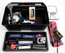 A collection of guitar accessories: including slides, tuners and pedal leads,