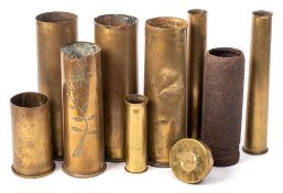 A WWI cast iron shell case, together with a group of WWI & WWII brass shell cases.
