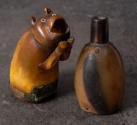 A Georgian horn snuff in the form of a cat: inset mother of pearl eyes with open mouth resting on