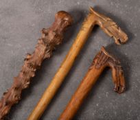 Two late 19th century traditional Greek carved horse head walking sticks: both with horse's head