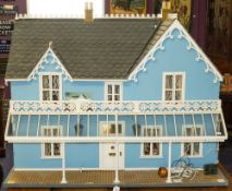 A large late 20th century Victorian style doll's house: with simulated slate roof over blue wall