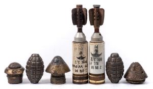 Two Mills bomb hand grenade casings together with three WWI period fuses,