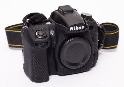 A Nikon D7000 Digital camera serial number 2208403 with silicone body cover:,