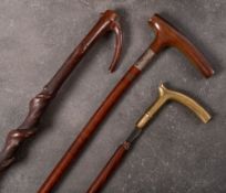 A silver mounted Plantation walking stick: (assay rubbed) together with a bras handled walking