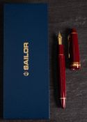 A Sailor (Japan) 1911 fountain pen: with 21k gold nib, maroon body and gilt mounts in original case.