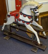 A Unicorn rocking horse:, with gilt spiral horn over painted face with glass eyes,